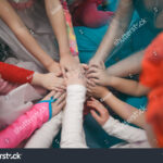 kids holding hands around world Children holding hands around the world royalty free vector
