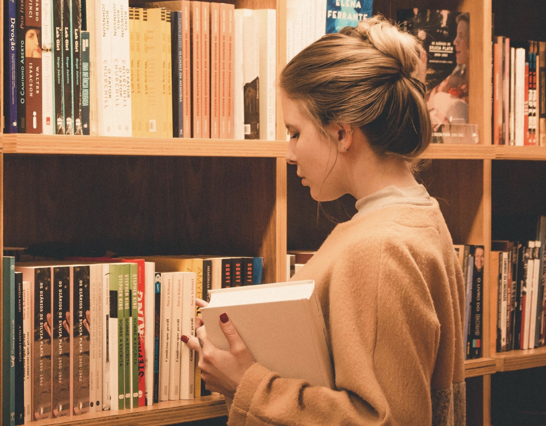 A person studying intensely with books and notes spread out around them