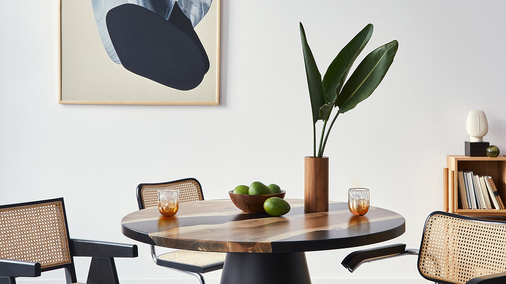 A modern, open-plan living space featuring natural light, minimalist furniture, and a focus on biophilic design elements, representing forward-thinking home design trends in 2024.